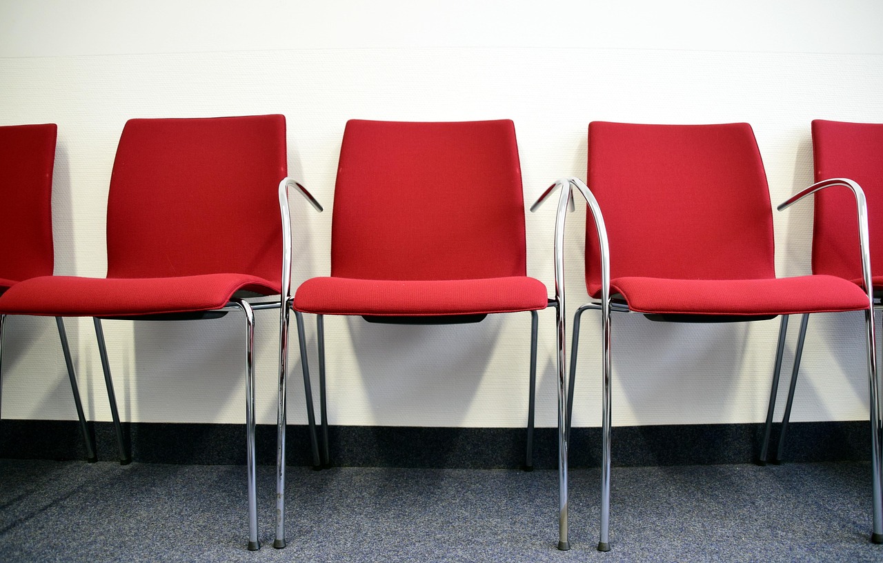 Empty waiting-room chairs in soft daylight
