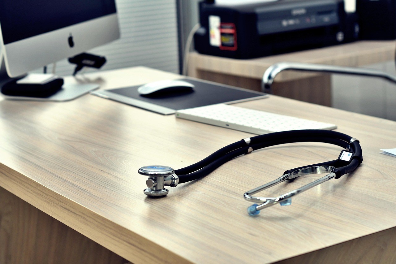 Stethoscope and notes on a consulting-room desk